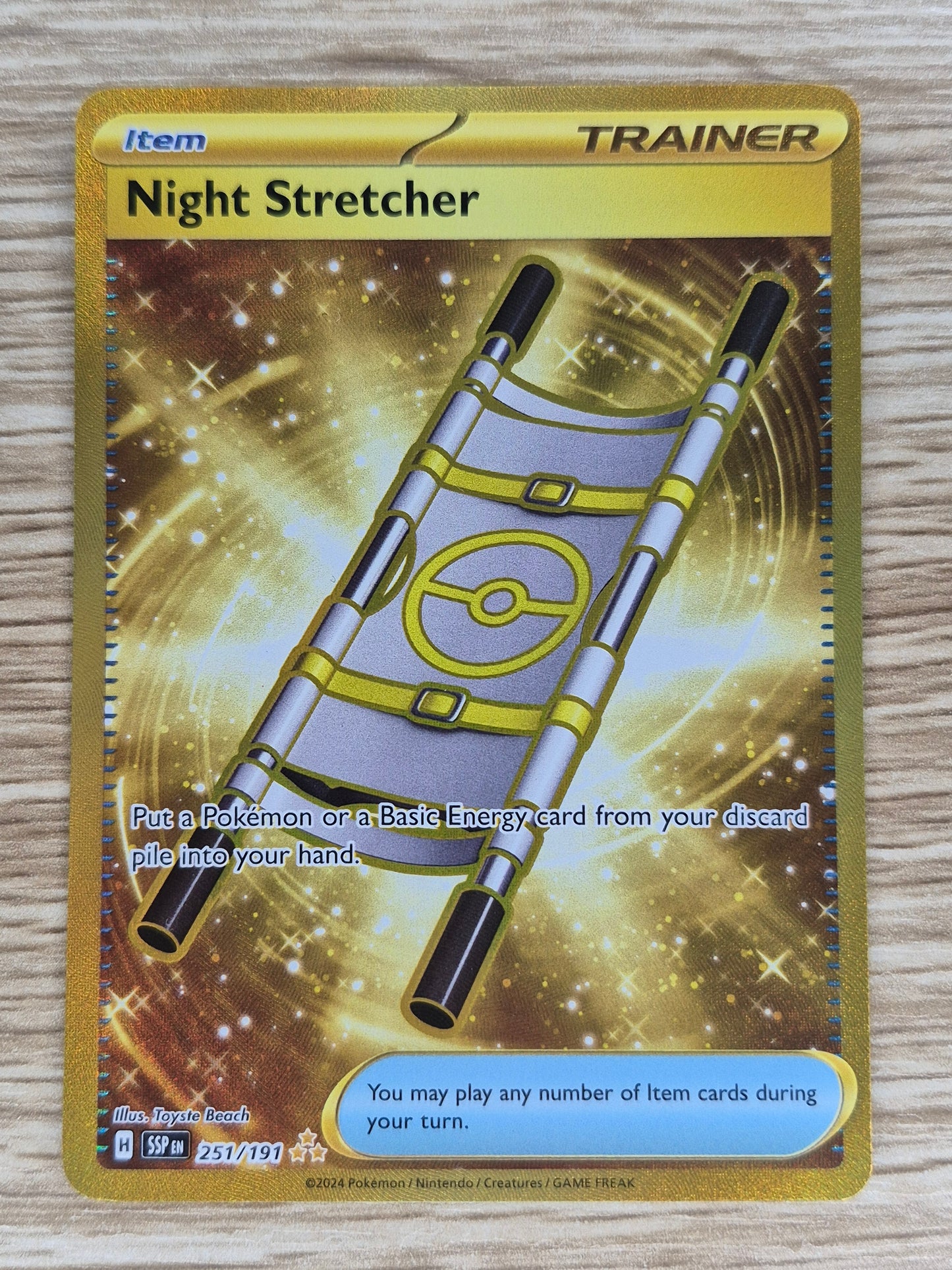 2024 Pokémon Surging Sparks 251/191 Gold Night Stretcher Full Art Rare